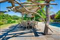 Willow and wood pergola beside the pool
