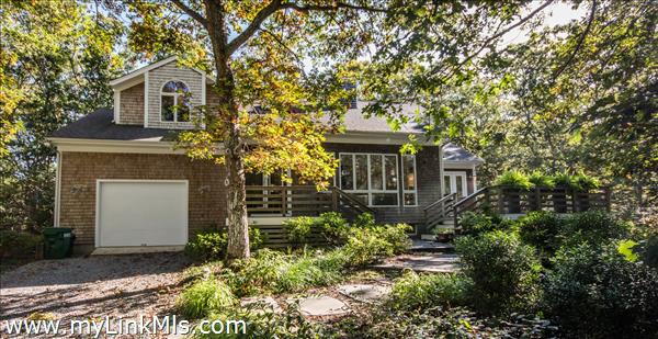 218 Lake Street private wooded setting yards away from Lake Tashmoo town dock and tennis courts.