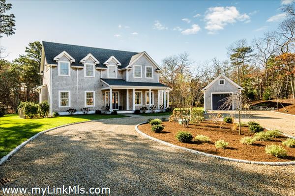 Coastal chic farmhouse with welcoming farmer\'s porch.