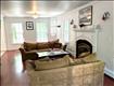 Large windows fill the living room with light.