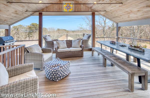 Open, airy, guest house porch with water views beyond!