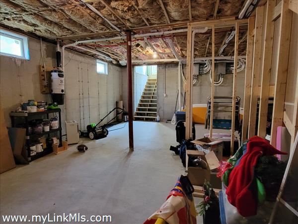 Unfinished basement with high ceilings.