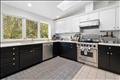Chefs kitchen with stainless steel appliances including Viking stove and Bosch dishwasher.