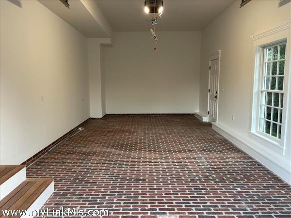 Attached one car garage with brick floor