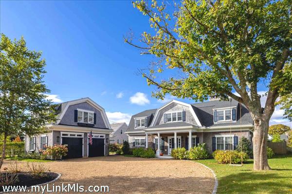 Gambrel style home with 2 car garage and living space above