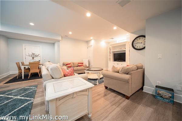 Finished basement with entertainment area, dining or game table, and lounge.