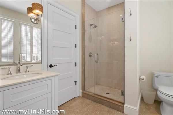 First floor primary en-suite tile bath with shower.