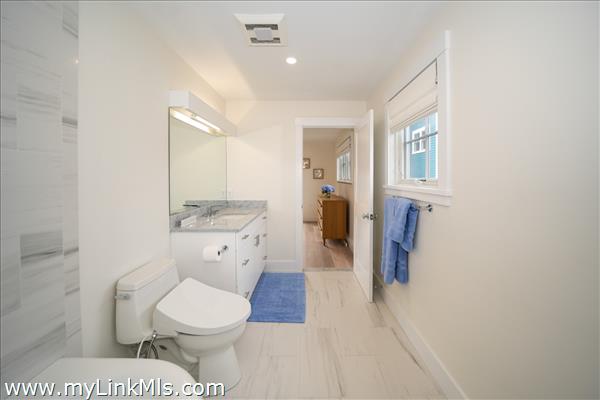 Primary tiled bath with tub and walk in closet