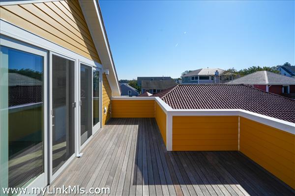 Mahogany Second Floor Deck includes grill hook up and water access.
