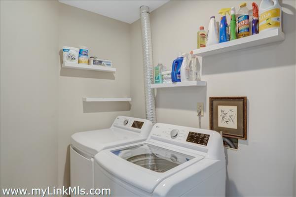 Spacious laundry room with storage.