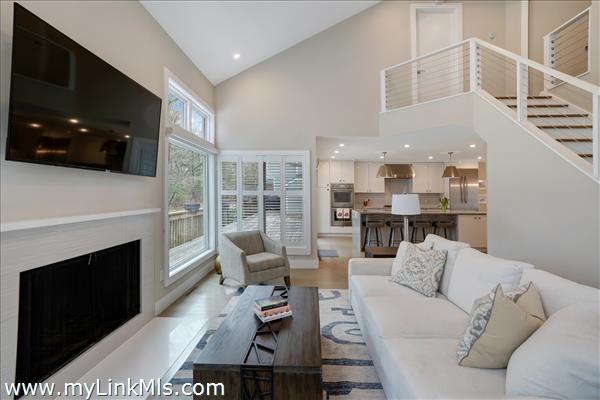 Light-filled living area with wood fireplace.