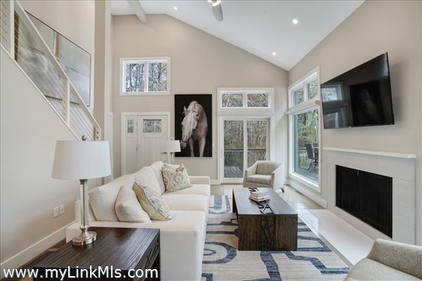 Light-filled living area with wood fireplace.
