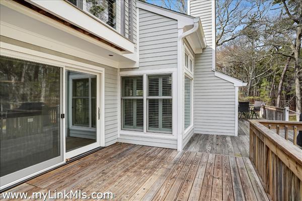A large deck wraps around the exterior of the unit.