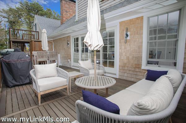 Deck off kitchen with propane grill.