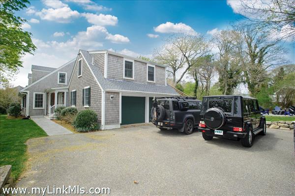 2 car garage with paved driveway