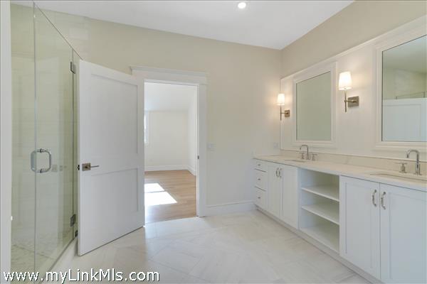 2nd floor primary bathroom with free standing tub, shower stall and private toilet room