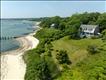 View of the home & beach with the inner harbor in the distance