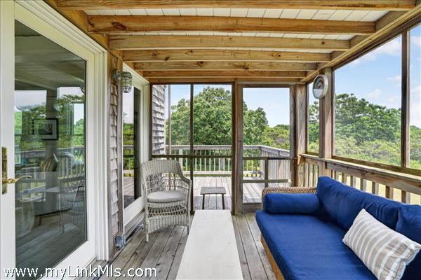 Wrap-around deck leads to the screened porch.