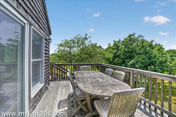 Elevated deck with stairs down to the yard.