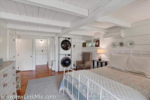 Lower-level bedroom with en suite bath and sliders out to the yard.