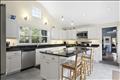 New kitchen with vaulted ceiling and granite countertops