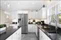 Kitchen with large refrigerator and double sinks