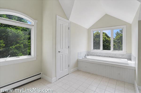 Primary en-suite bath with soaking tub and separate shower