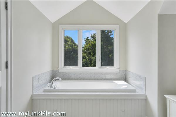 Primary en-suite bath with soaking tub and separate shower