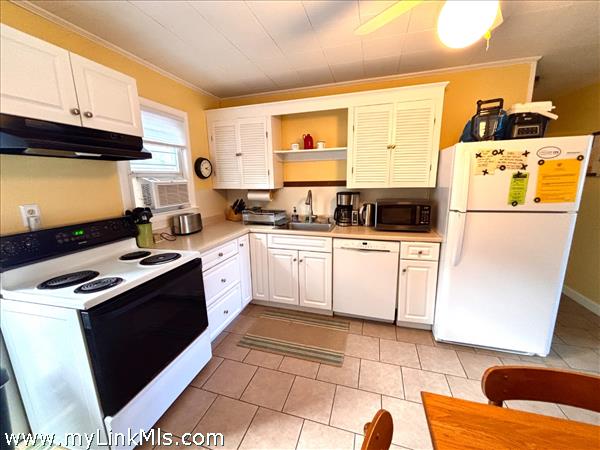 White Cabinetry with updated Tile Flooring