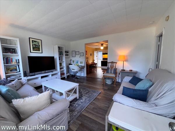 Spacious Living Area with Updated Flooring and Comfortable Furnishings