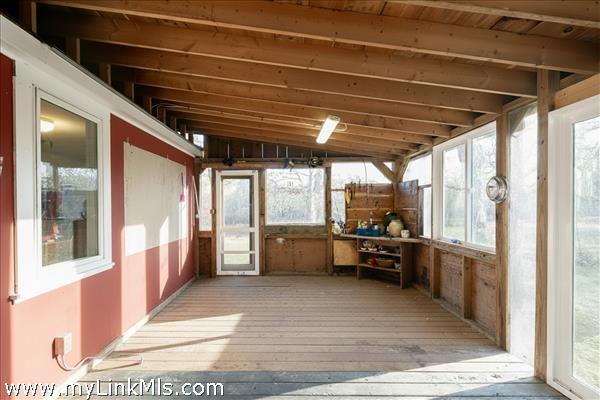 Three Season Porch with a Door to the Outdoor Shower and Sliding Doors with views to the Meadow.