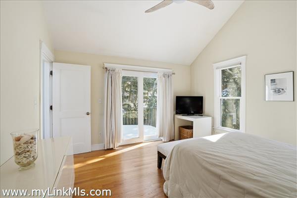 Primary bedroom with a forth slider to inviting deck.