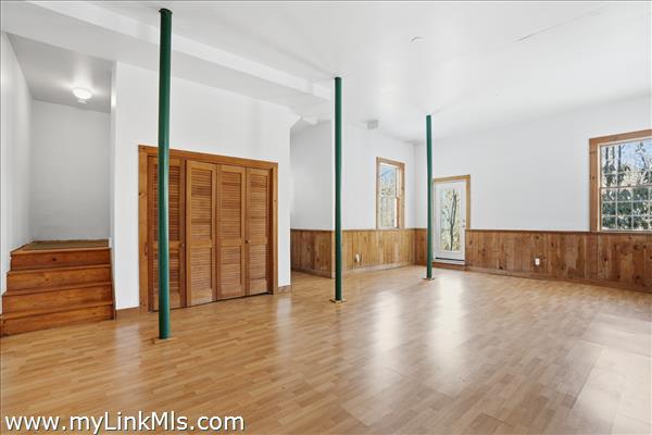 Bright basement with closet and door to the exterior 18 foot ceiling