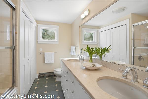 First floor full bath with double sinks and tub/shower, washer/dryer.