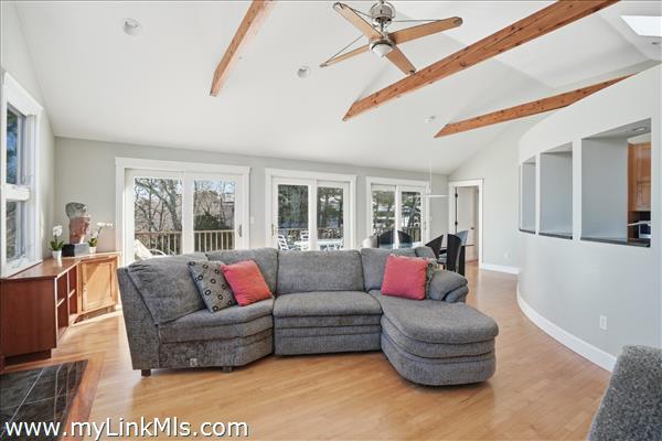 Bright open concept living space to outdoor deck three sliders