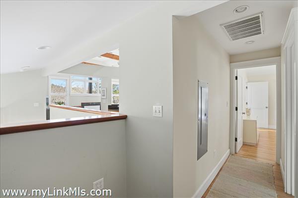 Primary suite with walk-in closet, sitting area, full bath with private access to exterior deck.