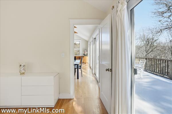Primary bedroom to living area with deck access.