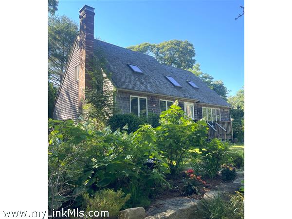 Beautiful front of house with stonewalls and plantings