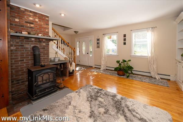 View of open front room area with wood burning stove.