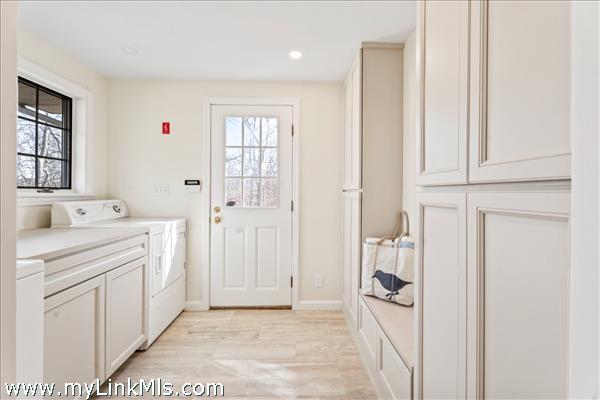 Side entrance mud room with Speed Queen washer & dryer, custom cabinetry renovated in 2025