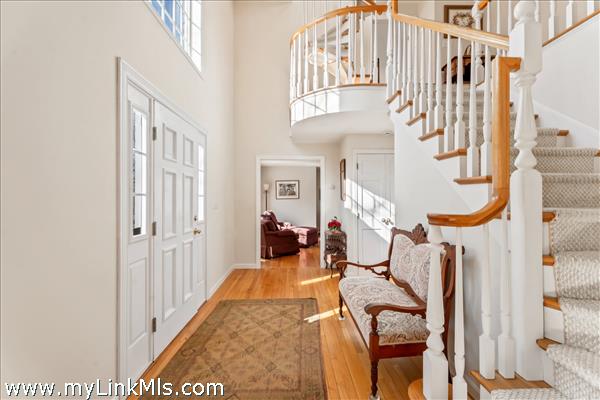Elegant carved staircase leads to the second floor from the grand foyer.