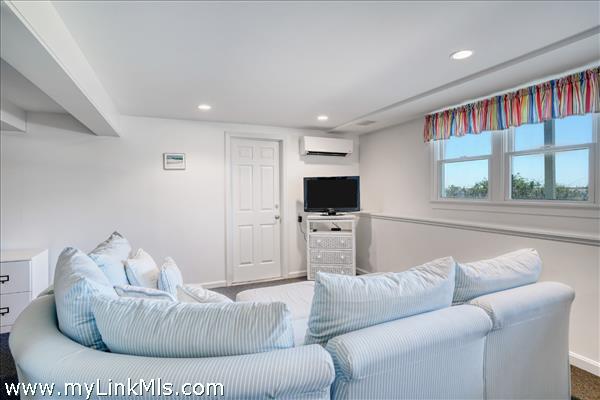 Finished lower level offering a spacious lounge area.