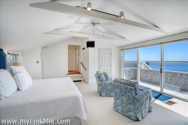 Primary bedroom sanctuary featuring a private sun deck and breathtaking waterviews