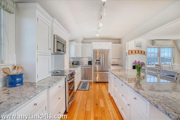 Polished granite countertops complement the custom cabinetry