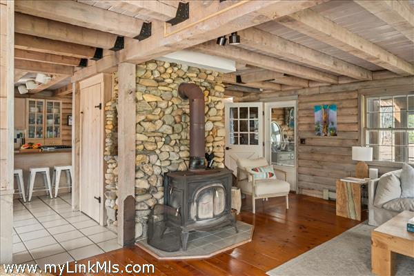 Beach stone chimney and wood stove for cozy gatherings with family and friends