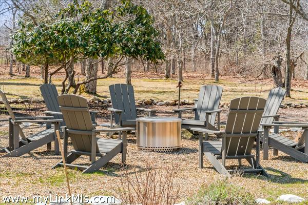Central firepit and circle of Adirondack chairs for evenings under the stars