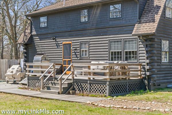 Main house back deck and patio area with grill and outdoor shower