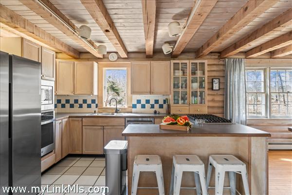 Kitchen with counter seating and stainless appliances