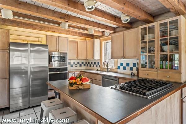 propane range with griddle, new stainless wall oven and inset microwave.