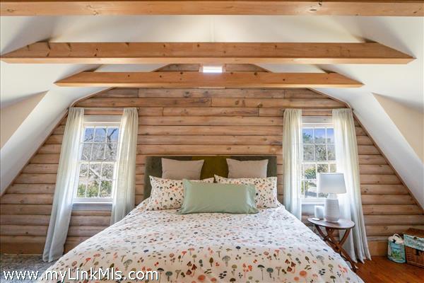 2nd flr - Primary Bedroom with walk-in closet wood floors and vaulted ceilings